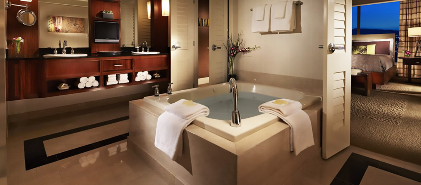 hotel bathroom with natural stone tile flooring
